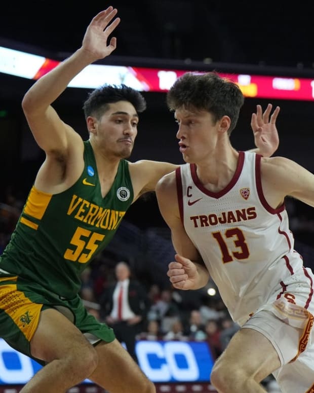 Nov 15, 2022; Los Angeles, California, USA; Southern California Trojans guard Drew Peterson (13) dribbles the ball against Vermont Catamounts guard Robin Duncan (55) in the first half at Galen Center. Mandatory Credit: Kirby Lee-USA TODAY Sports